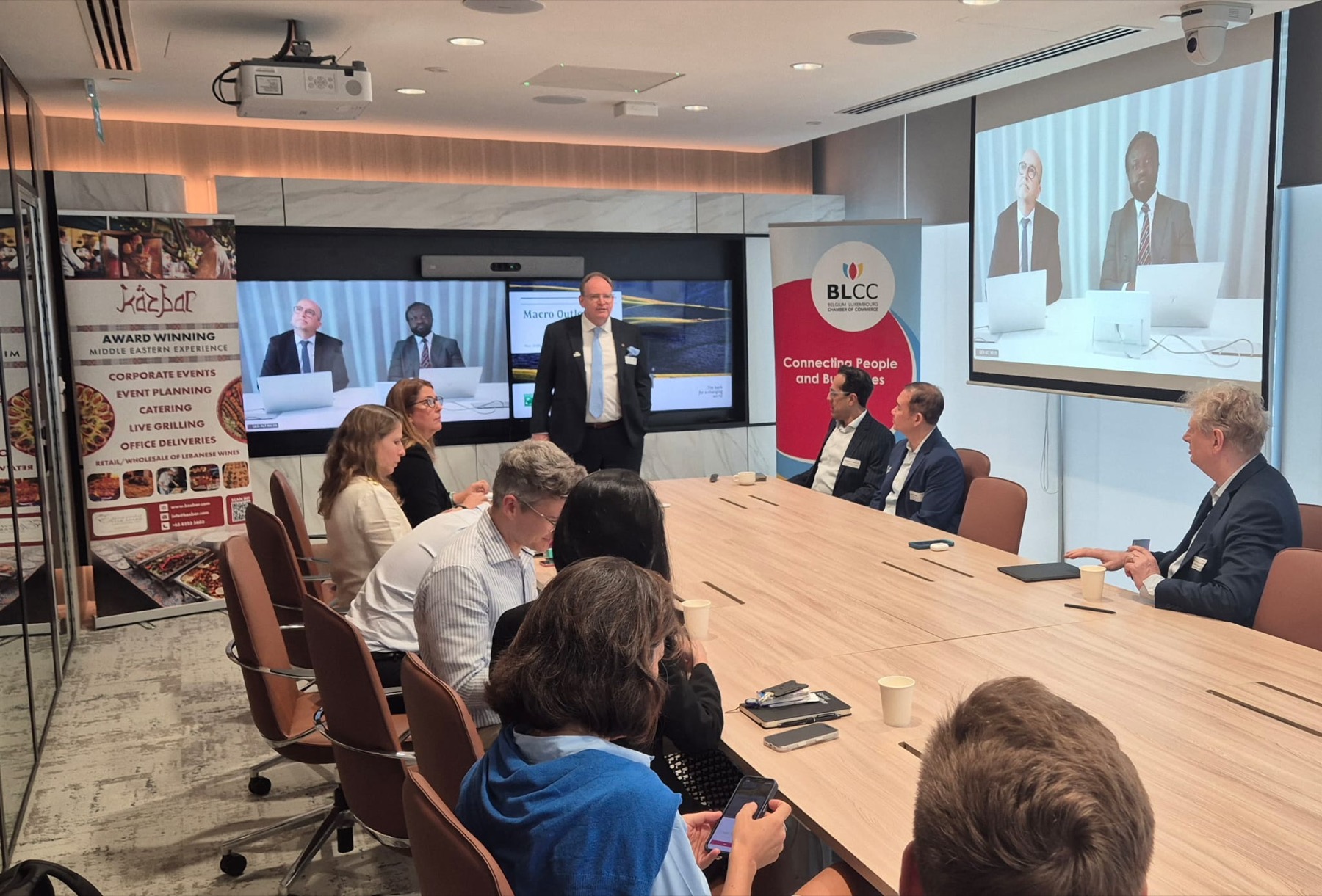 Members seated around a boardroom table beside a BLCC banner reading Connecting People and Businesses